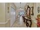 Inviting hallway with ceramic tile flooring, neutral paint, and decorative console table at 4337 Summer Breeze Way, Kissimmee, FL 34744