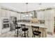Bright kitchen features stainless steel appliances, granite countertops, and counter seating at 4337 Summer Breeze Way, Kissimmee, FL 34744