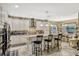 Bright kitchen boasts stainless steel appliances, granite countertops, and barstool seating at a spacious island at 4337 Summer Breeze Way, Kissimmee, FL 34744