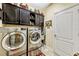 Laundry room features stainless steel washer and dryer and dark cabinetry at 4337 Summer Breeze Way, Kissimmee, FL 34744