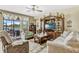 Comfortable living room with tile flooring, neutral paint, and a sliding glass door to the lanai at 4337 Summer Breeze Way, Kissimmee, FL 34744