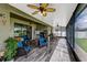 Large screened patio with ceiling fans, rocking chairs and various seating areas at 4337 Summer Breeze Way, Kissimmee, FL 34744