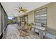 Large screened patio with ceiling fans, rocking chairs, grill and seating area at 4337 Summer Breeze Way, Kissimmee, FL 34744