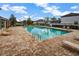 Community pool with lounge chairs and brick-paved deck at 4337 Summer Breeze Way, Kissimmee, FL 34744