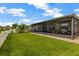 Spacious screened porch overlooking a well-manicured backyard and lake at 4337 Summer Breeze Way, Kissimmee, FL 34744