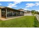 Enclosed porch and expansive backyard with a pristine white picket fence at 4337 Summer Breeze Way, Kissimmee, FL 34744