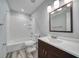 Bathroom featuring a shower/tub combo with white tile surround, modern vanity, and updated fixtures at 525 Georgetown Dr # D, Casselberry, FL 32707