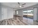 Bright, modern bedroom with light gray walls, wood-look floors, ceiling fan, and sliding doors to a balcony at 525 Georgetown Dr # D, Casselberry, FL 32707