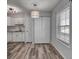Dining area features wood-look floors, storage closet, and natural light from a large window at 525 Georgetown Dr # D, Casselberry, FL 32707