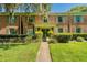 Charming two-story brick building featuring traditional architecture, vibrant green shutters, and well-manicured landscaping at 525 Georgetown Dr # D, Casselberry, FL 32707