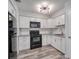Updated kitchen with white cabinets, granite countertops, subway tile backsplash, and stainless steel appliances at 525 Georgetown Dr # D, Casselberry, FL 32707