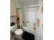 Cozy bathroom features a toilet, shower with curtain, and storage at 5501 Rosebriar Way # 111, Orlando, FL 32822