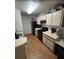 Efficient kitchen with black appliances, white countertops and cabinets, and ample storage space at 5501 Rosebriar Way # 111, Orlando, FL 32822