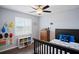 Cozy bedroom featuring a ceiling fan and a window providing natural light at 5512 Hamlin Close, Davenport, FL 33896