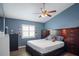 Comfortable bedroom with blue walls, a ceiling fan, and a warm, inviting atmosphere at 5512 Hamlin Close, Davenport, FL 33896