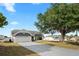 Well-maintained home with a spacious driveway and lush front yard at 5512 Hamlin Close, Davenport, FL 33896