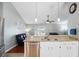 Open concept kitchen featuring granite countertops, stainless steel appliances and sightlines into the living room at 5512 Hamlin Close, Davenport, FL 33896