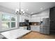 Bright kitchen featuring stainless steel appliances, granite countertops and a table with bench seating at 5512 Hamlin Close, Davenport, FL 33896