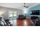 Bright living room with hardwood floors, slider to patio and modern ceiling fan at 5512 Hamlin Close, Davenport, FL 33896