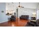 Open concept living room featuring hardwood floors, vaulted ceilings and sightlines into the kitchen at 5512 Hamlin Close, Davenport, FL 33896