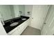 Bathroom with double sinks, granite countertop, large mirror, and stylish cabinets at 5624 Beggs Rd, St Cloud, FL 34771