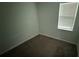 A simple bedroom with neutral walls, carpet, and a window letting in natural light at 5624 Beggs Rd, St Cloud, FL 34771
