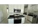 Stainless steel appliances and black granite countertops at 5624 Beggs Rd, St Cloud, FL 34771