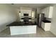 Modern kitchen featuring stainless steel appliances, granite countertops, and a spacious island at 5624 Beggs Rd, St Cloud, FL 34771