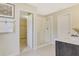 This bathroom features a glass enclosed shower, a vanity with a grey cabinet, and opens to the closet at 6413 Clover St, Lake Hamilton, FL 33851
