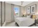 Bedroom with neutral walls, carpet flooring, a ceiling fan, and a large window with patterned drapes at 6413 Clover St, Lake Hamilton, FL 33851