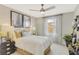 Comfortable bedroom featuring neutral tones, carpeted floors, and natural light from a window with sheer curtains at 6413 Clover St, Lake Hamilton, FL 33851