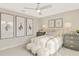 This cozy bedroom boasts neutral walls and a ceiling fan and is decorated with skates-themed artwork at 6413 Clover St, Lake Hamilton, FL 33851