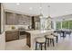 Modern kitchen features an island with stool seating, stainless steel appliances, and ample cabinet space at 6413 Clover St, Lake Hamilton, FL 33851