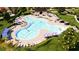 Community pool area with lounge seating, tables, umbrellas, and manicured landscaping at 6413 Clover St, Lake Hamilton, FL 33851