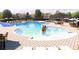 Community pool with lounge chairs, umbrellas, water features, and ample seating at 6413 Clover St, Lake Hamilton, FL 33851