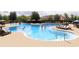View of a community pool with sunbathers, chairs, tables, umbrellas, and water features at 6413 Clover St, Lake Hamilton, FL 33851