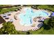 Overhead shot of a community pool area with plenty of lounge chairs and shade umbrellas at 6413 Clover St, Lake Hamilton, FL 33851