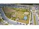 Aerial view of neighborhood featuring playground, basketball court, and dog park at 6452 Sprucepine Ln, St Cloud, FL 34771