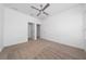 Bright bedroom featuring plush carpet, a ceiling fan, and a closet at 6452 Sprucepine Ln, St Cloud, FL 34771