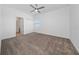 Bright bedroom featuring plush carpet, a ceiling fan, and a closet at 6452 Sprucepine Ln, St Cloud, FL 34771