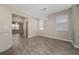 Bright dining area features stylish chandelier, neutral walls and wood look tile flooring, and bright windows at 6452 Sprucepine Ln, St Cloud, FL 34771