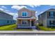 Charming two-story home with stone accents, landscaped front yard, and inviting covered porch at 6452 Sprucepine Ln, St Cloud, FL 34771