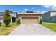 Spacious two-car garage with a brick paver driveway, offering convenient parking at 6452 Sprucepine Ln, St Cloud, FL 34771