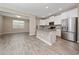 Modern kitchen with stainless steel appliances, a center island, and light wood-look flooring at 6452 Sprucepine Ln, St Cloud, FL 34771