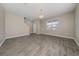 Spacious living area with neutral paint, wood look tile floors and large window for natural light at 6452 Sprucepine Ln, St Cloud, FL 34771
