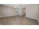 Open living area features neutral walls and wood look tile flooring with views of adjacent dining and powder bath at 6452 Sprucepine Ln, St Cloud, FL 34771