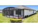 A screened lanai provides a comfortable outdoor living space off of the back of this bright home at 684 San Augusto Dr, Poinciana, FL 34759