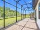 The screened-in lanai offers unobstructed views of the green lawn and a perfect space to unwind outdoors at 684 San Augusto Dr, Poinciana, FL 34759