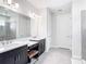 Bright bathroom features dual sinks, vanity, and modern fixtures at 684 San Augusto Dr, Poinciana, FL 34759