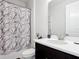 Bright bathroom with a modern vanity, decorative shower curtain, and neutral wall color at 684 San Augusto Dr, Poinciana, FL 34759